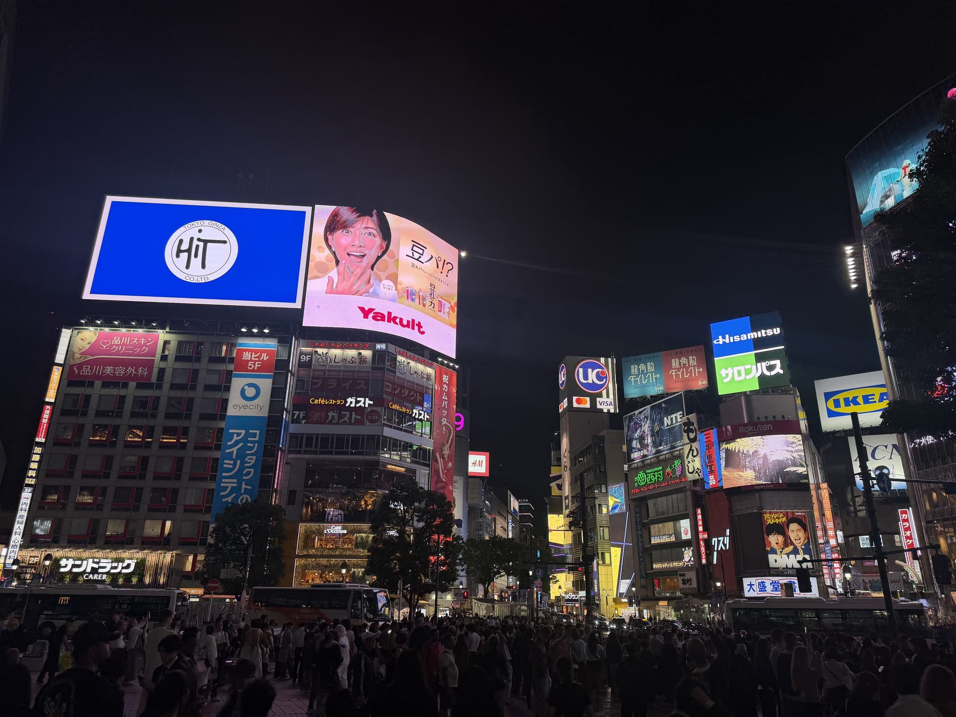 Neon billboards lighting a Tokyo street at night