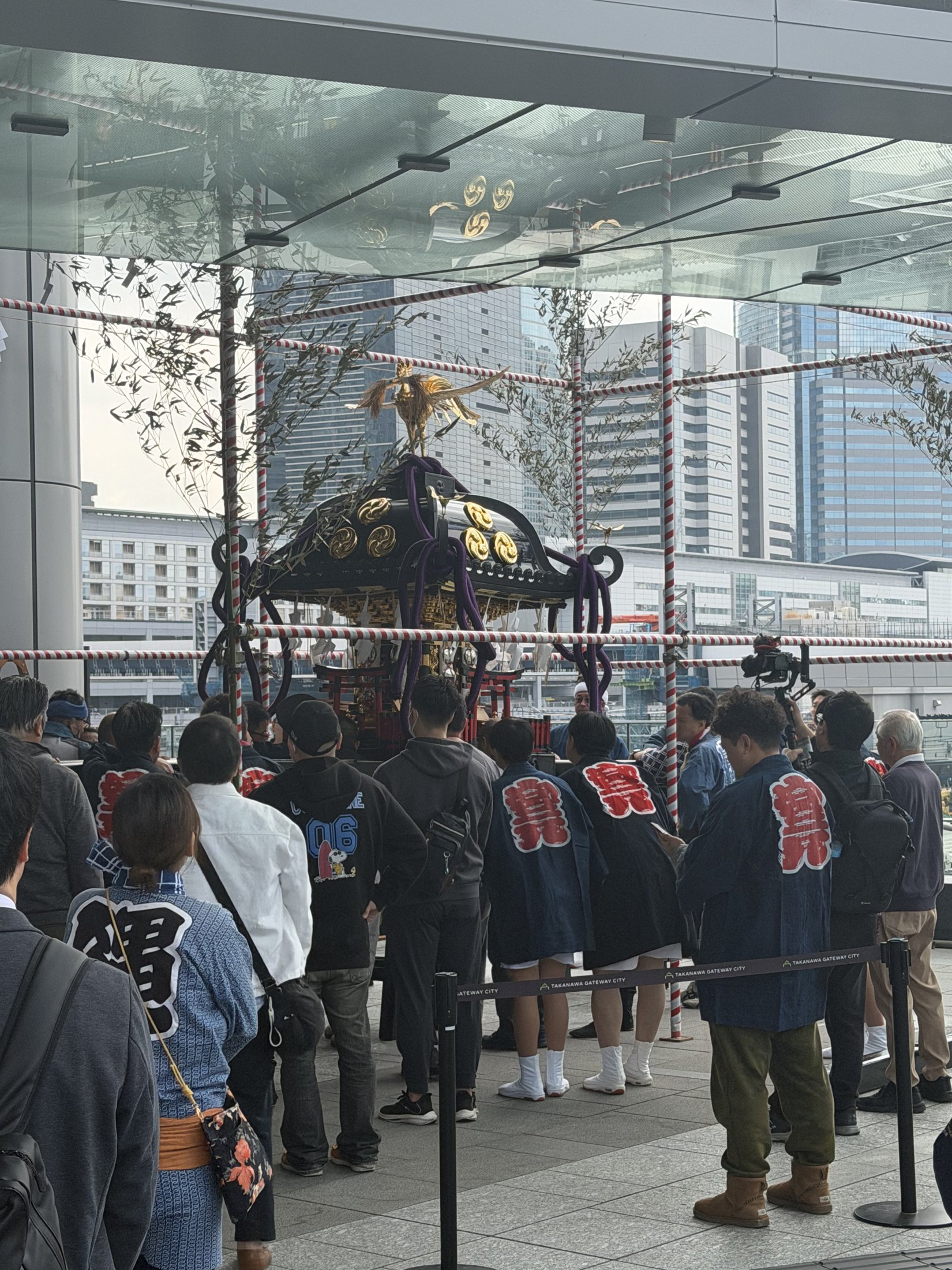 Residents carrying a mikoshi portable shrine through a Tokyo street during a matsuri festival